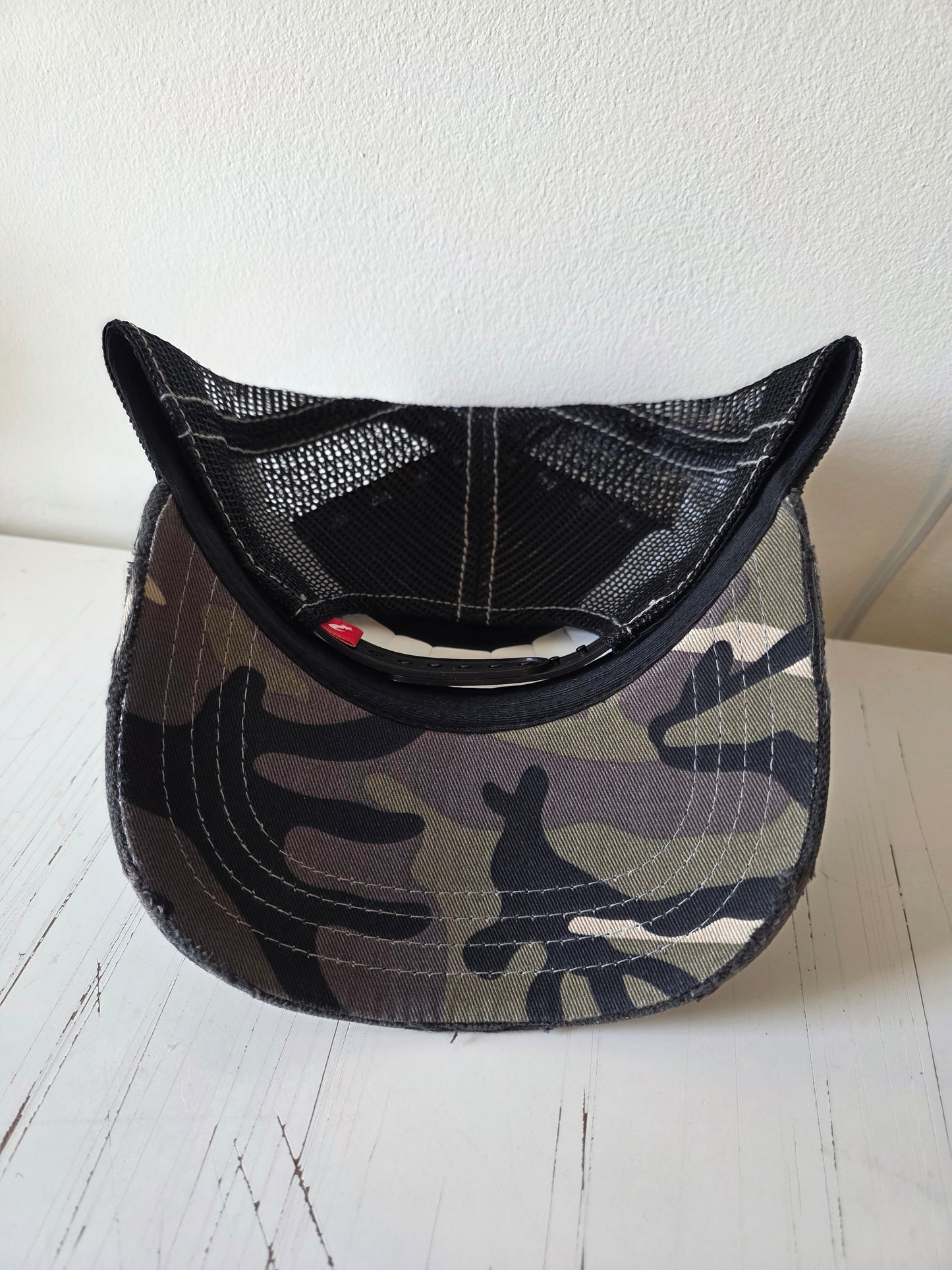 Black & white distressed hat with studded crystal and a leather patch.