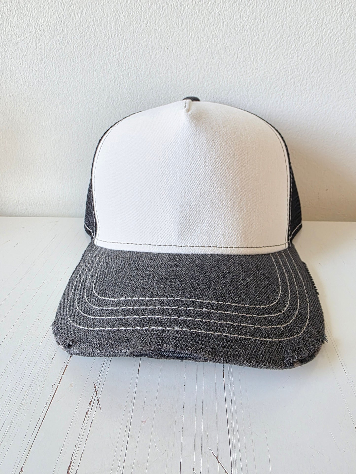 Black & white distressed hat with studded crystal and a leather patch.